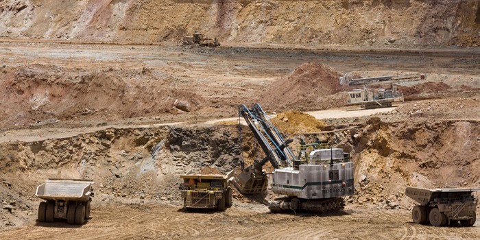 Camiones y excavadoras en una mina de oro a cielo abierto