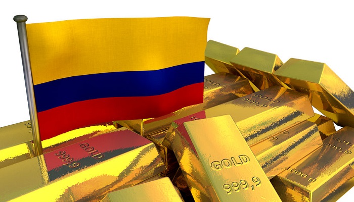 Bandera de Colombia y lingotes de oro