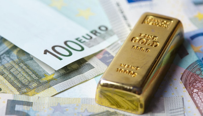 Lingotes de oro sobre billetes de euro