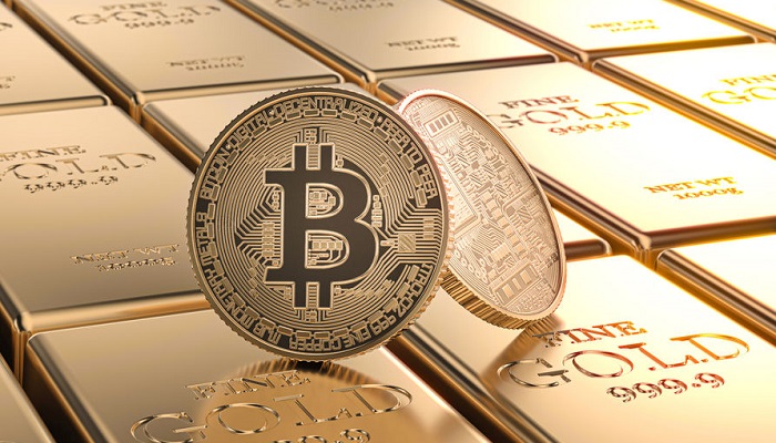 Moneda bitcoin sobre lingotes de oro