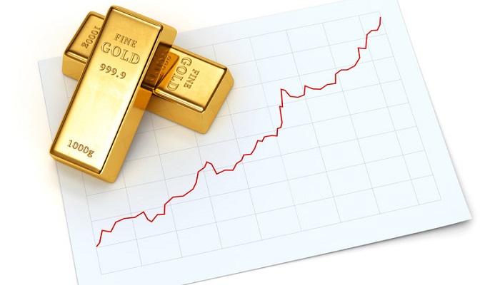 LIngotes de oro sobre gráfico de subida